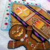 Closeup of Cookies & Scream gingerbread man. Details are clearly visible. Stitches are neat and tidy. Windows are fiery and have blood dropping down them. Candycanes are bright purple and black, and very shiny. Frosting is on the roof, with smarties