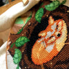 Work in progress of the Sleeping Fox. The fox is being stitched using the Danish method. An embroidery hoop frames the design. Stitches are nice, tidy and fluffy. Colors in this scene are mainly brown, orange, green and beige.